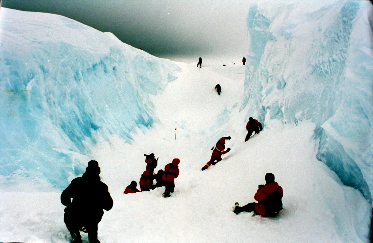 The Ross Ice Shelf front — climbers for scale on a 30-metre ice cliff at the edge of the world's largest floating ice shelf